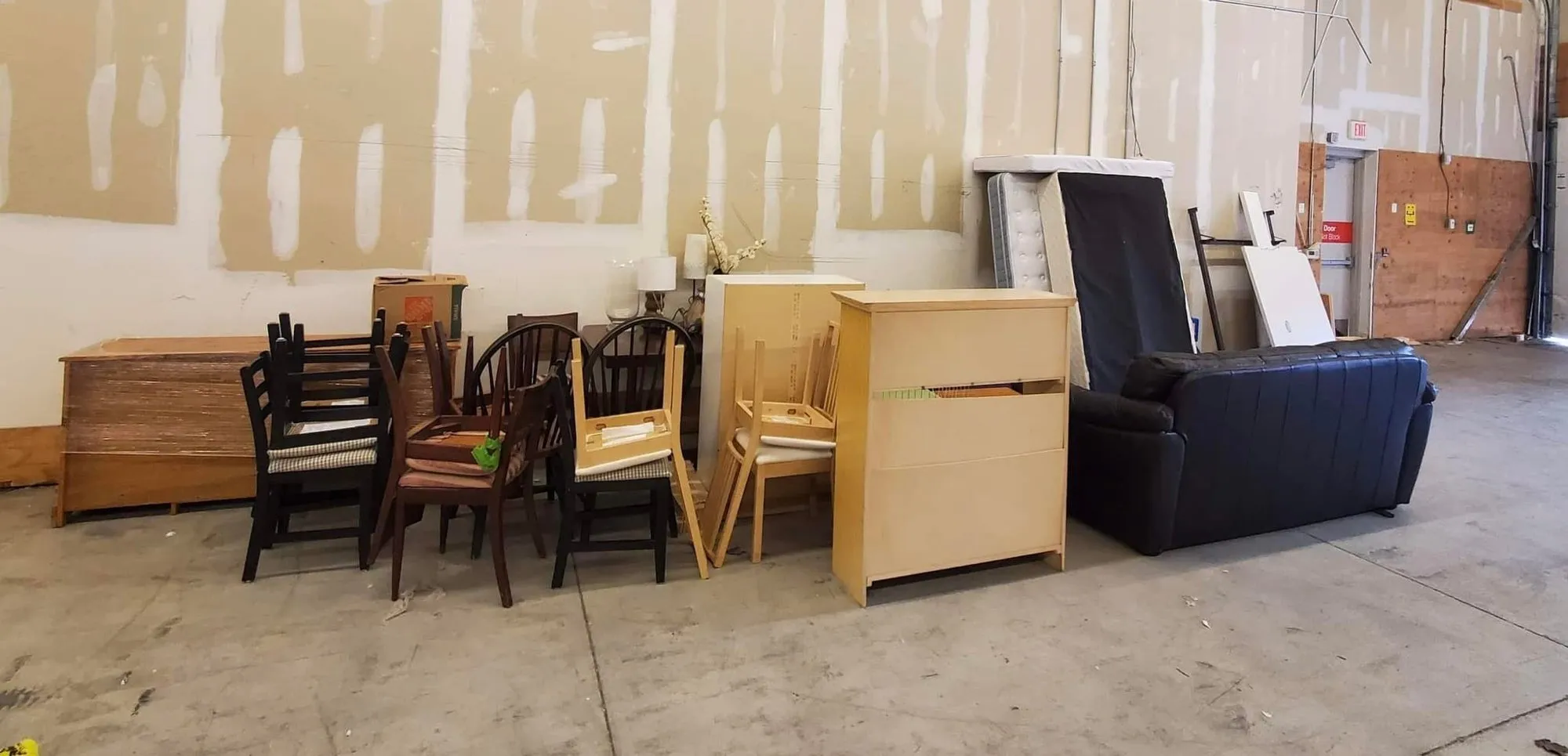 Volunteers standing together next to collected furniture