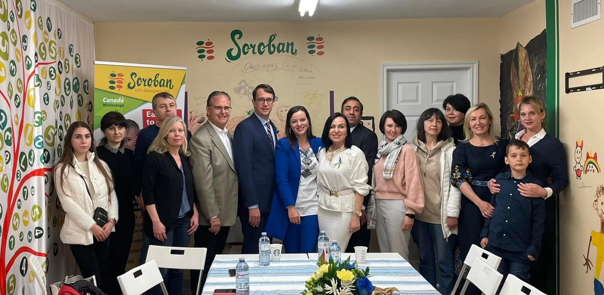 A group of newly arrived Ukrainian families with Ontario officials