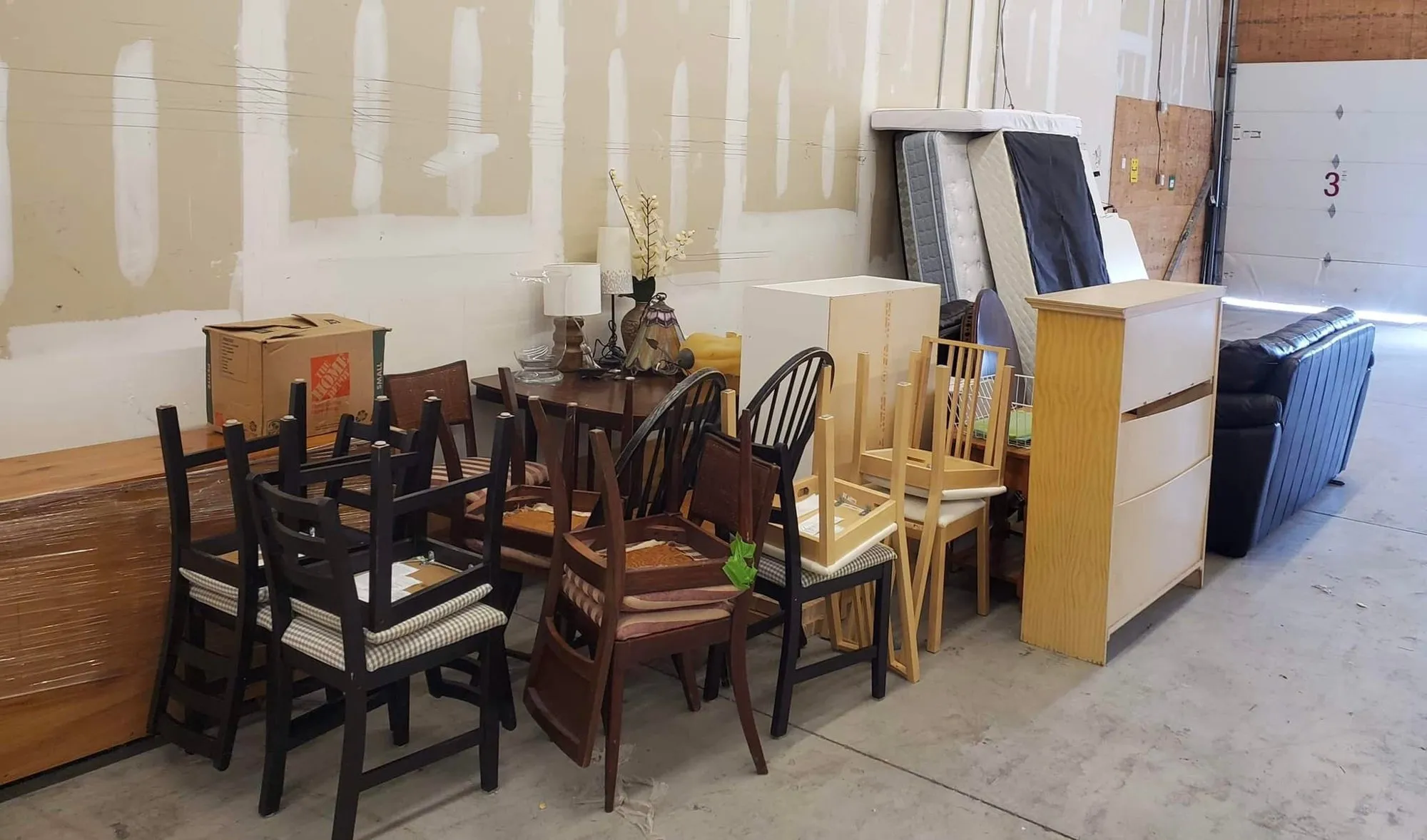 Volunteers standing together next to collected furniture