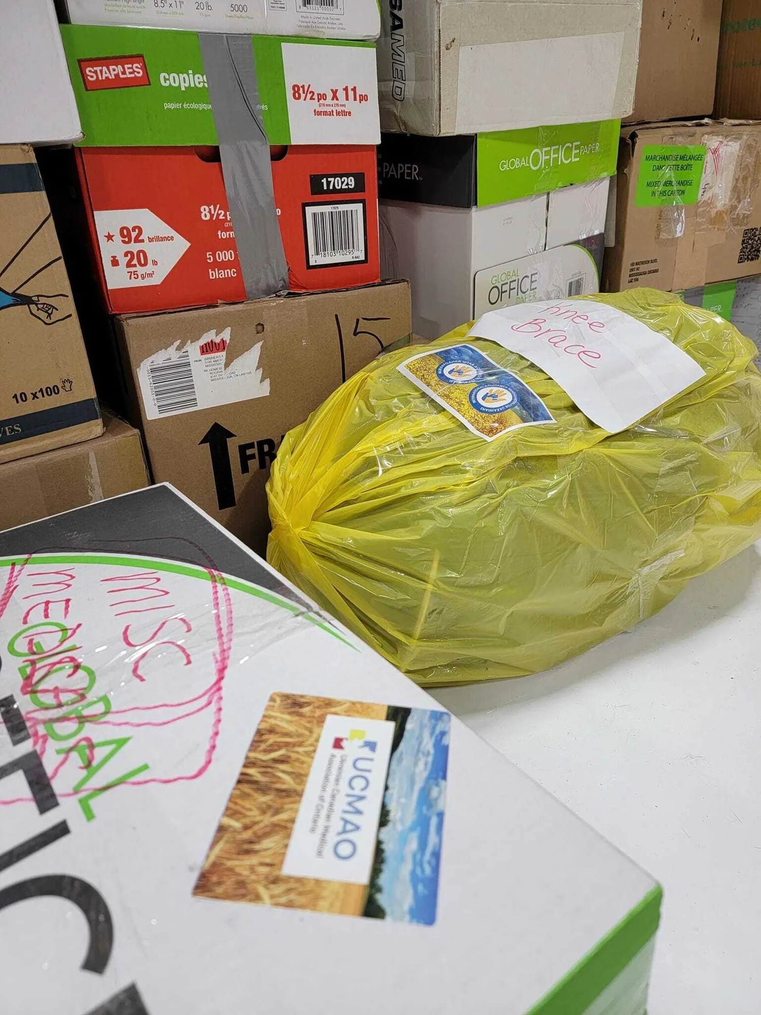 Boxes of medications and supplies with UCMAO labels in a warehouse